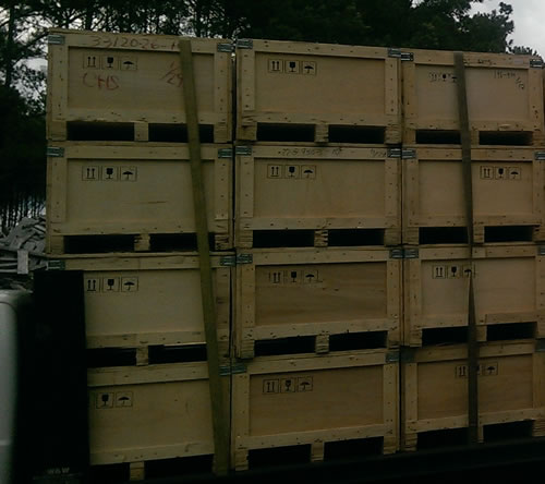 Stacks of wooden crates on flatbed truck.
